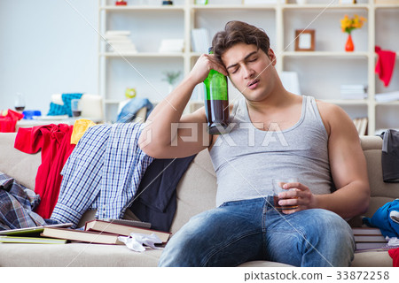 Young man student drunk drinking alcohol in a 33872258