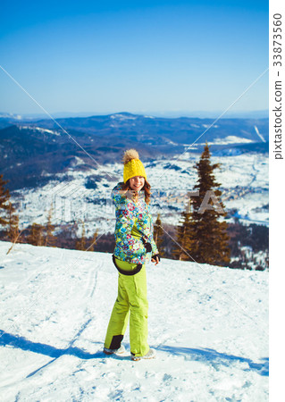 a woman stands in the mountains in winter 33873560