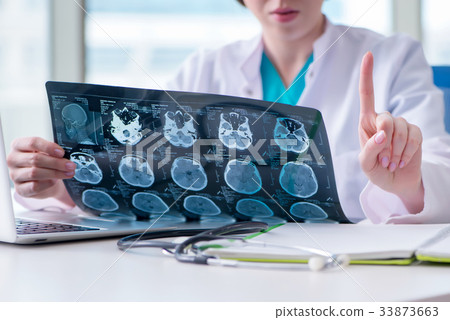 Doctor examining MRI image in hospital Doctor examining MRI image in hospital 33873663