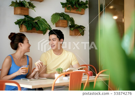 Enjoying breakfast Enjoying breakfast 33874276