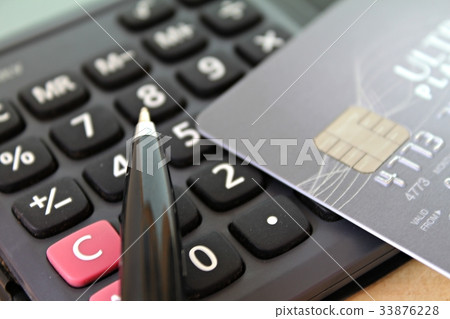 Credit card and pen on calculator Credit card and pen on calculator 33876228