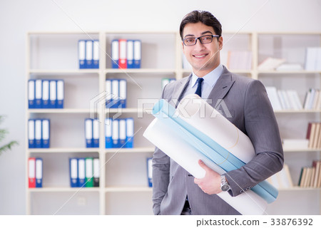 Businessman engineer draftsman with blueprints 33876392