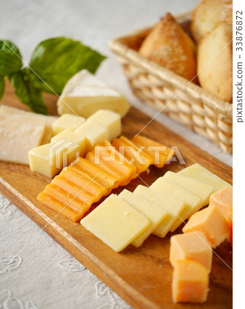 Variety cheese and scones Wooden board (vertical position) 33876872