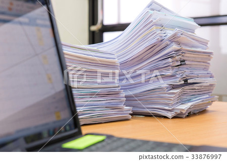 computer notebook and documents on desk  33876997