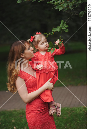 girl looks at unknown berries in park girl looks at unknown berries in park 33879409