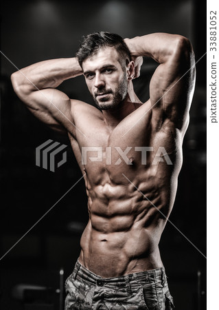 Caucasian sexy fitness model in gym close up abs. 33881052