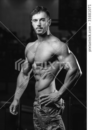 Caucasian sexy fitness model in gym close up abs. 33881071