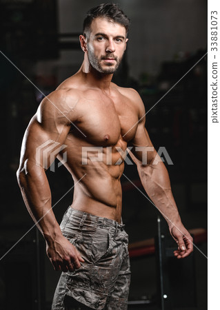 Caucasian sexy fitness model in gym close up abs. 33881073
