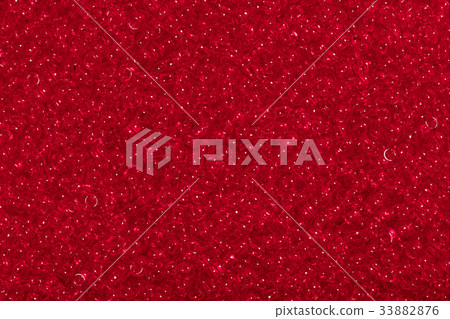Seed beads of dark red color on the textile Seed beads of dark red color on the textile 33882876