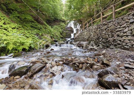 Cascade waterfall Shipit on a fast mountain river Cascade waterfall Shipit on a fast mountain river 33883979