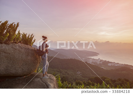 Hipster young girl with backpack enjoying sunset Hipster young girl with backpack enjoying sunset 33884218