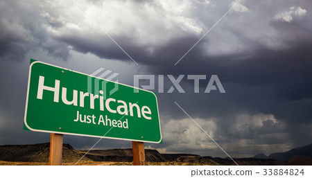 Hurricane Green Road Sign and Stormy Clouds Hurricane Green Road Sign and Stormy Clouds 33884824