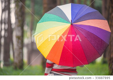 Beautiful women with colorful umbrella standing Beautiful women with colorful umbrella standing 33887895