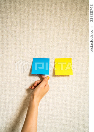 Woman taking sticky notes 33888748