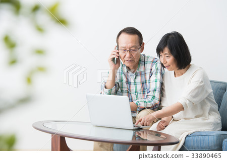Senior man and woman who operate a personal computer Senior man and woman who operate a personal computer 33890465