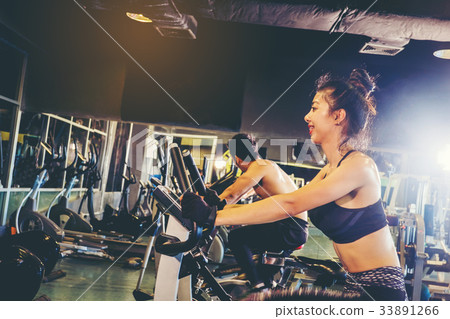 Group of people in the gym exercising legs Group of people in the gym exercising legs 33891266