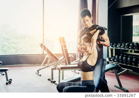 Sport girl doing weight exercises working Sport girl doing weight exercises working 33891267