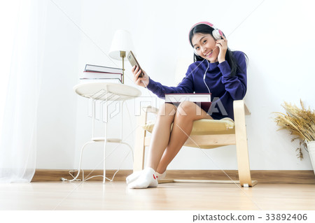 Female teenage cheerful listening smart phone 33892406