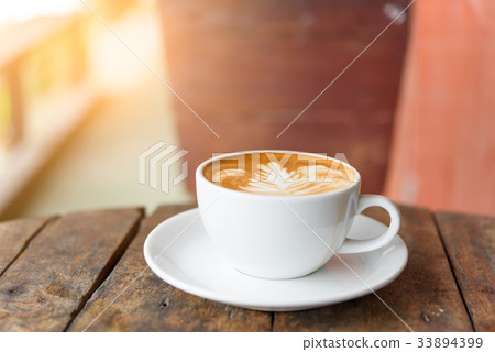 coffee cup Latte art on  vintage blue wood table  33894399