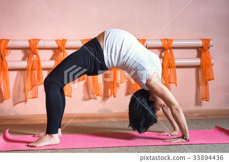 pregnant woman doing yoga exercises. Wheel pose. pregnant woman doing yoga exercises. Wheel pose. 33894436