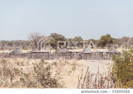 Mud straw and wooden hut in the bush, Africa 33895088