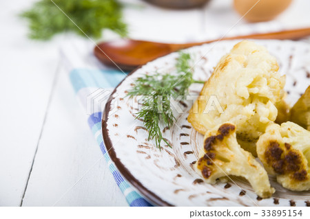 Fried cauliflower on a wooden table. 33895154