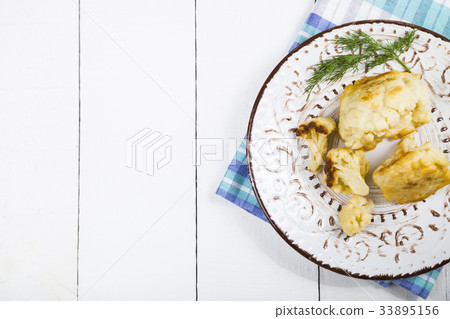 Fried cauliflower on a wooden table. 33895156