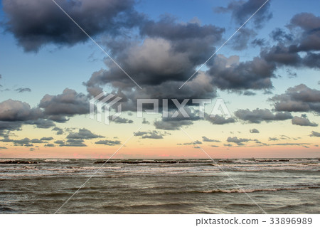 Dramatic cloudscape over the sea at sunset 33896989