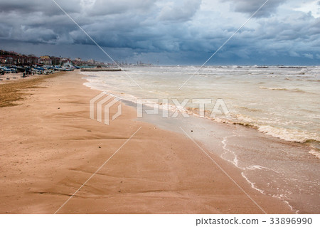 Sand coast with dramatic sky and roll 33896990