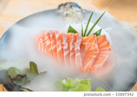 Raw salmon slice sashimi in n Japanese restaurant. 33897342