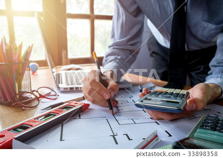 Architect working on blueprint Architect working on blueprint 33898358