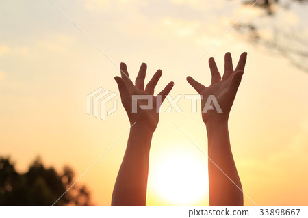 hands praying for blessing from god on sunset  33898667