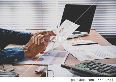 Businessman analyzing investment charts Businessman analyzing investment charts 33899651
