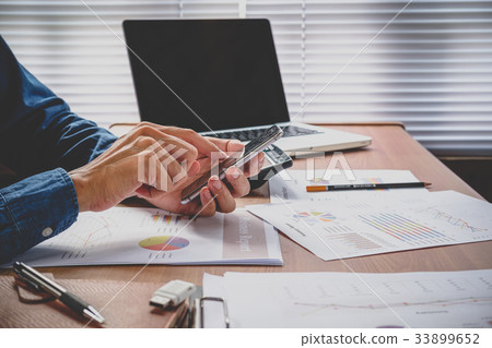Businessman working and using smart phone Businessman working and using smart phone 33899652