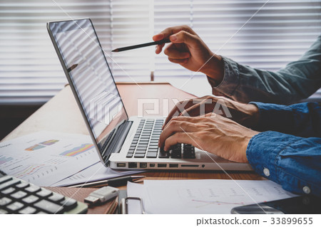 Two colleagues using laptop Two colleagues using laptop 33899655