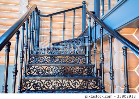 Black forged iron staircase close up 33902918