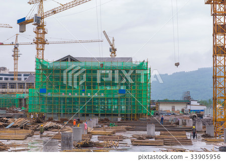 Crane and workers at Building construction site Crane and workers at Building construction site 33905956