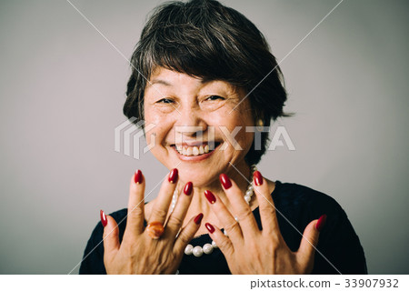 Senior woman with red nail Senior woman with red nail 33907932