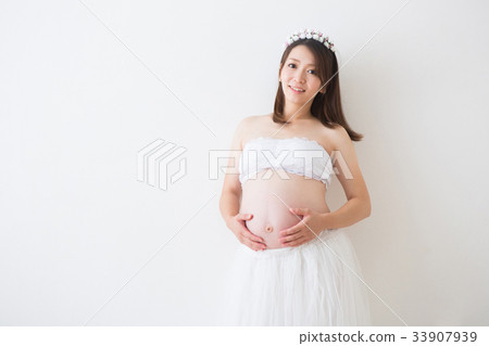 Pregnant woman wearing a dress Pregnant woman wearing a dress 33907939