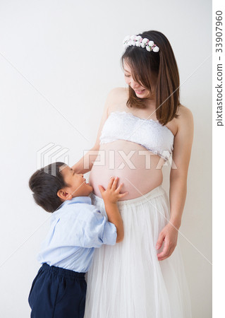 Pregnant woman in a dress with a boy 33907960