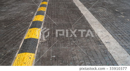 Road bump on the road for reduce speed. Road bump on the road for reduce speed. 33910377
