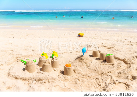 Sandcastles on a beach  the sea in the background. 33911626
