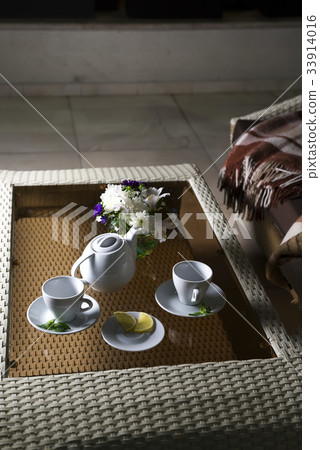 plaid on the sofa and hot tea in table plaid on the sofa and hot tea in table 33914016