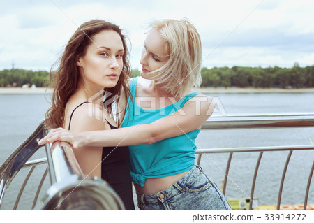 Two women are flirting. Two women are flirting. 33914272
