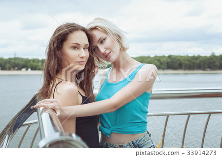 Lovely women are flirting. 33914273