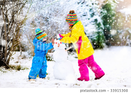 Kids building snowman. Children in snow Winter fun 33915308