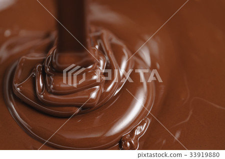 pouring melted premium dark chocolate 33919880
