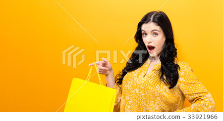 Young woman holding a shopping bag  33921966
