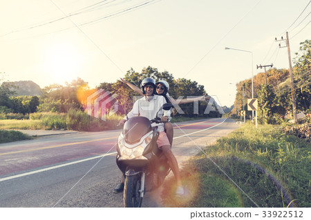 Happy Couple Riding Motorcycle In Countryside 33922512