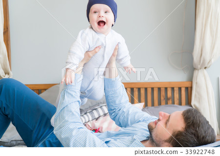 Close-up portrait of happy young father hugging Close-up portrait of happy young father hugging 33922748